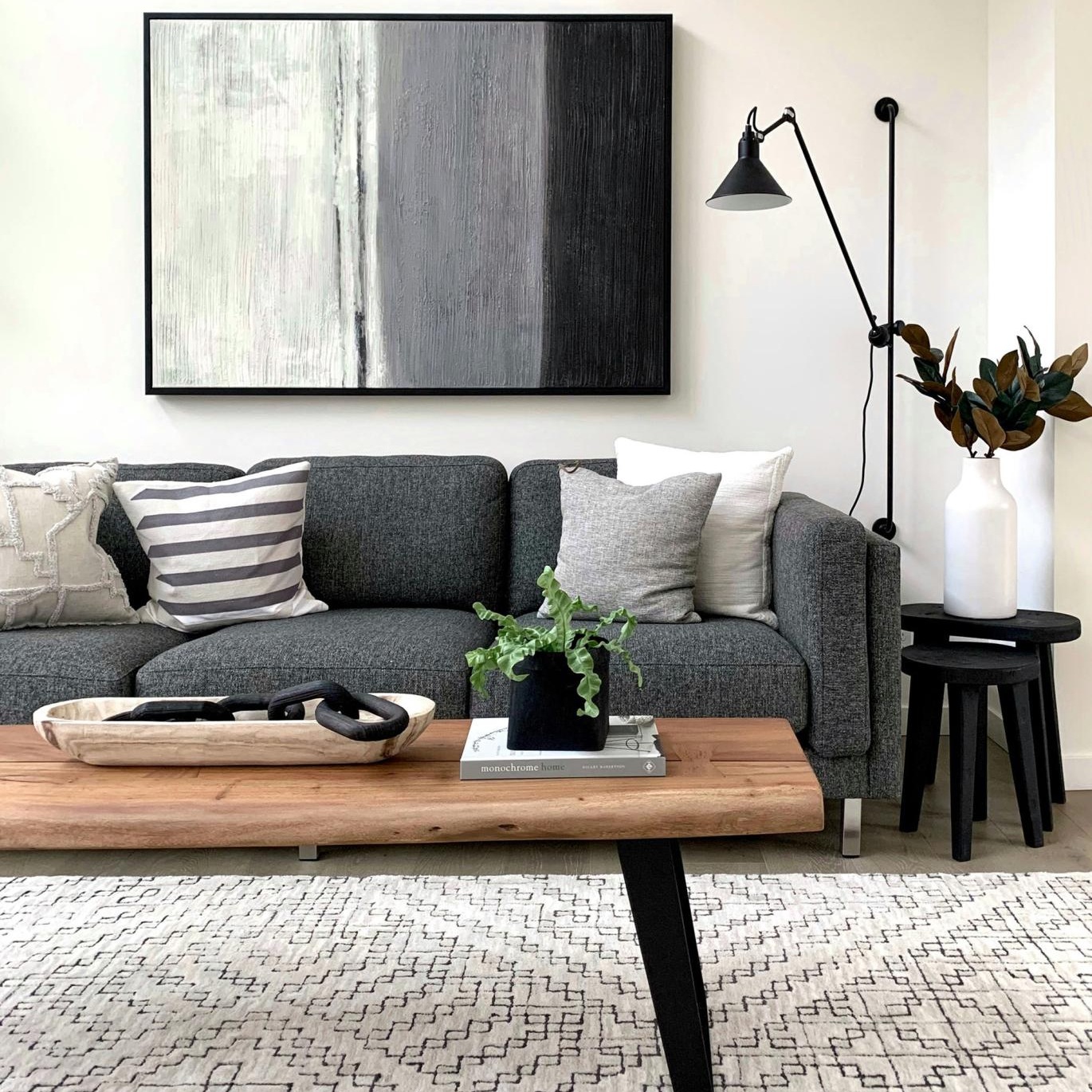 a couch with a coffee table with a plant and decor on it